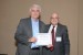 Dr. Nagib Callaos, General Chair, giving Prof. Tomas Zelinka the best paper award certificate of the session "Control Systems and Communication Technologies." The title of the awarded paper is "Service Quality Management in the ITS Telecommunications Systems."
